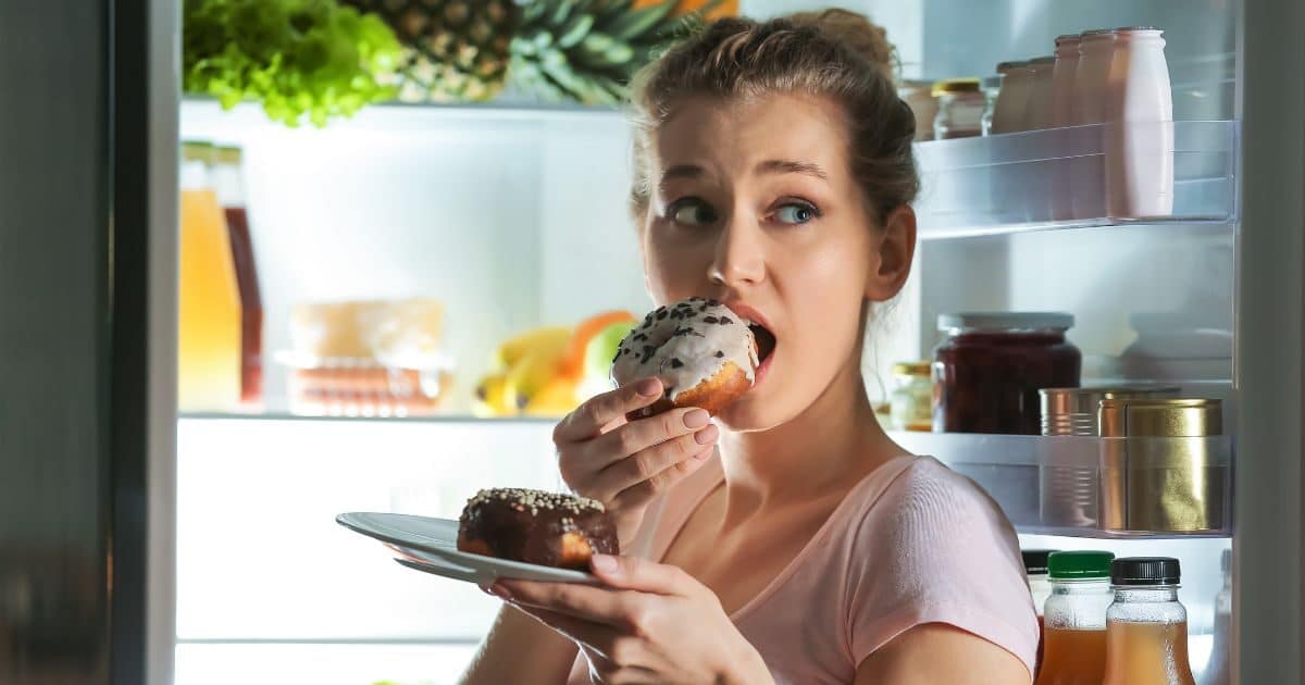 Girl eating sandwich. how to overcome emotional eating.